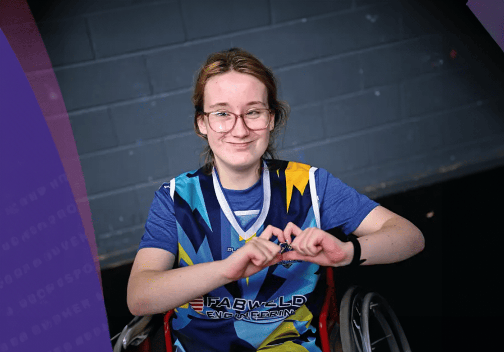 Young girl in wheelchair wearing a sports jersey. 