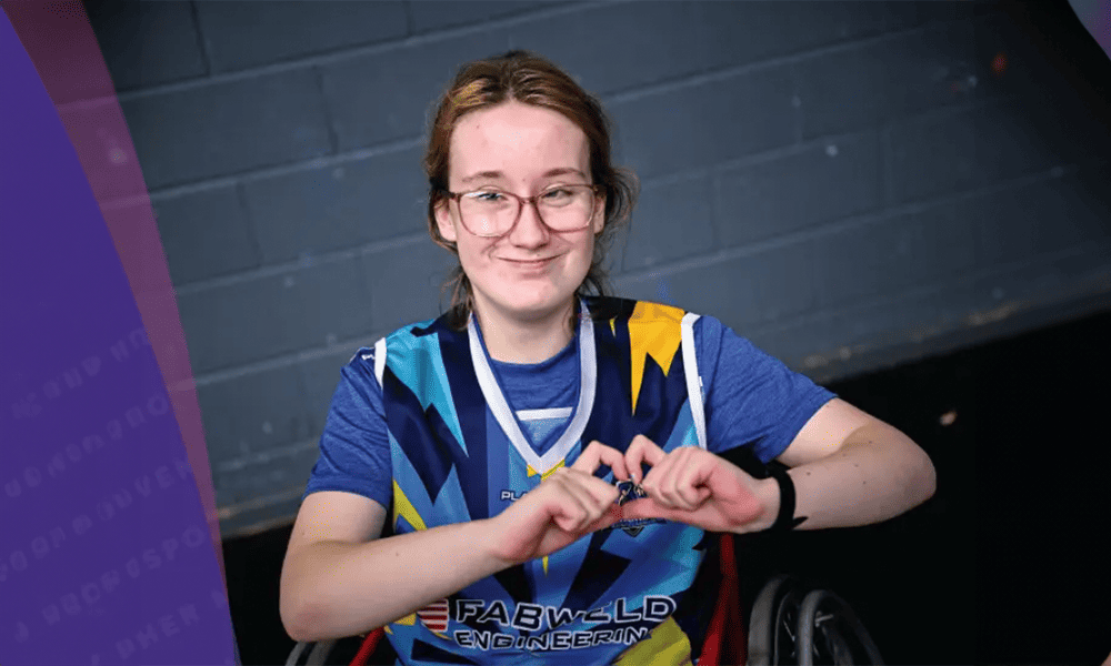 Young girl in wheelchair wearing a sports jersey.